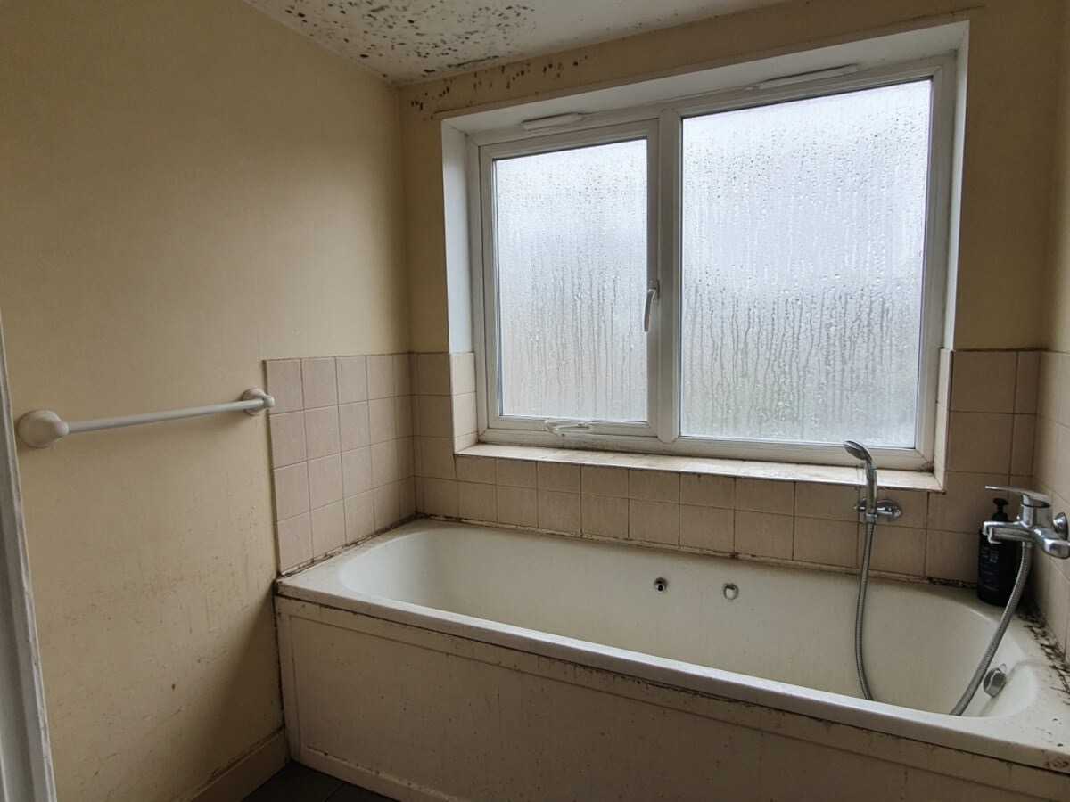 AI-generated illustration - Before: condensation and mould on outside wall, not a photo of an EYR job